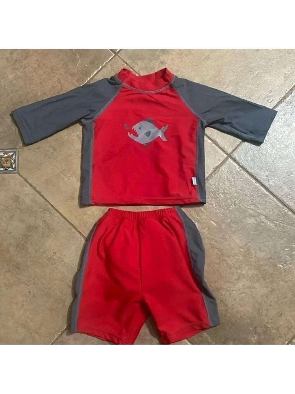 I play boys shark swim shirts and shirt size 12 months